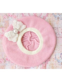 Crochet baby hat with white rosette bow