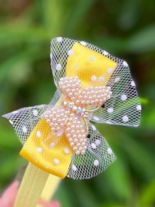 Handmade yellow lace romper with pearls, butterflies, tulle, and matching headband – perfect for special occasions.