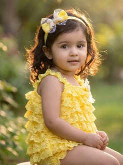 Handmade yellow lace romper with pearls, butterflies, tulle, and matching headband – perfect for special occasions.