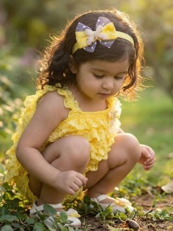 Girl yellow lace romper with pearls, butterflies, tulle, and matching headband – perfect for special occasions. Girl yellow lace romper with pearls, butterflies, tulle, and matching headband – perfect for special occasions.