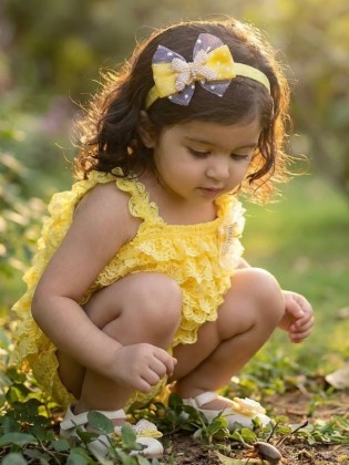 Handmade yellow lace romper with pearls, butterflies, tulle, and matching headband – perfect for special occasions.
